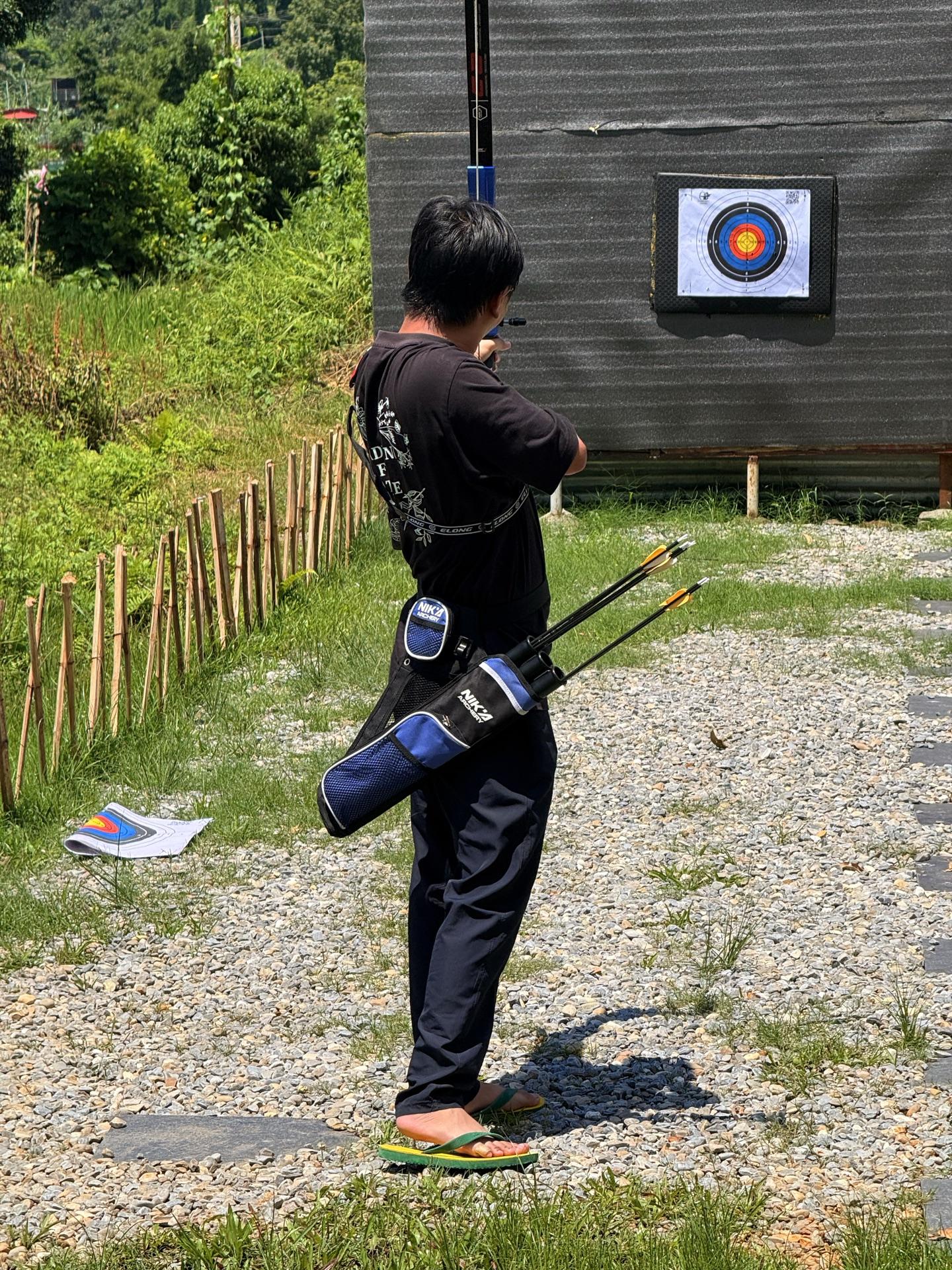 A friend with a quiver of arrows sizing up the target, in chappals