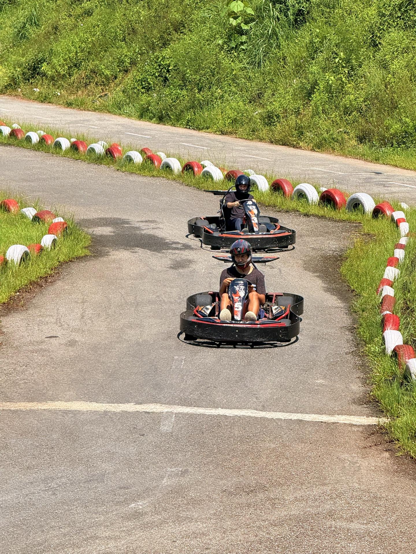 Two go-karts racing through a corner of the track