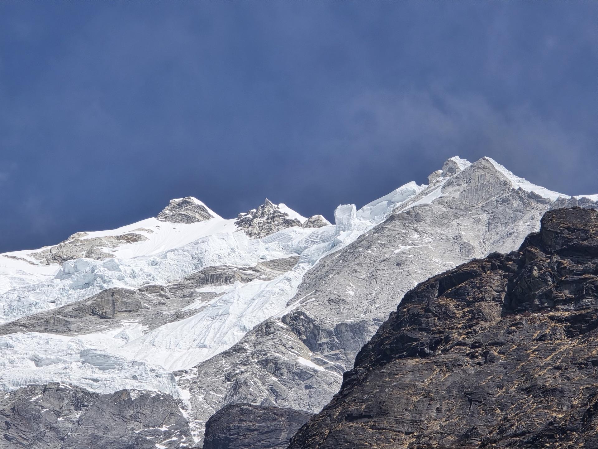A hanging glacier filling the frame above dark rock