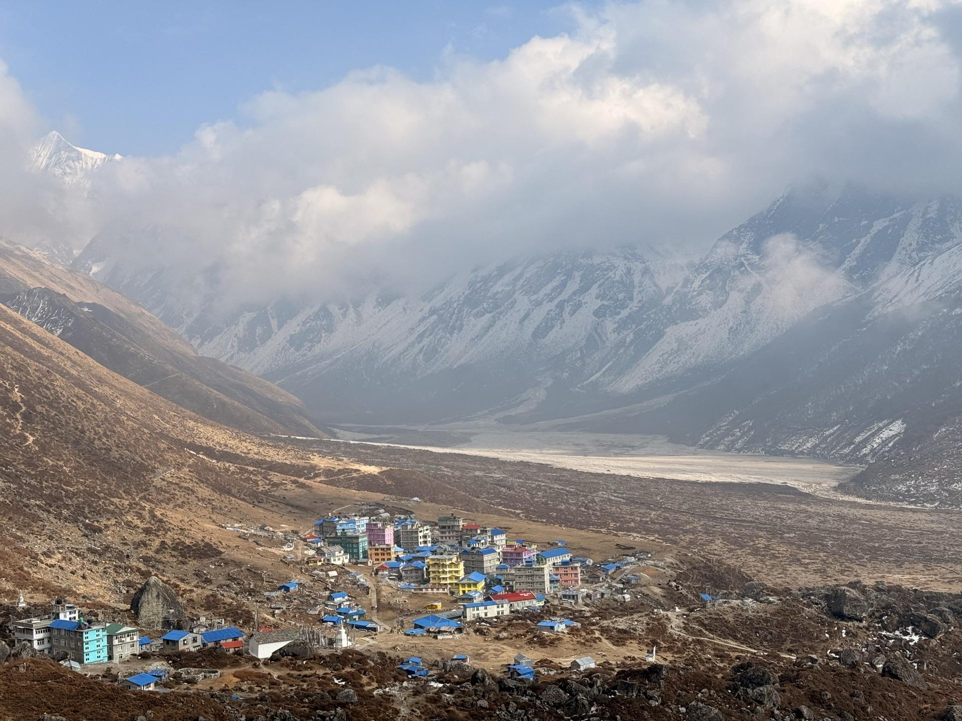 The colorful roofs of Kyanjin Gompa seen from the slope above
