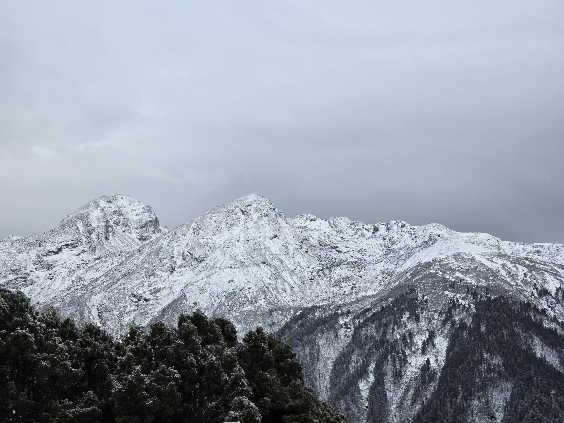 The range across the valley freshly dusted in snow under grey sky