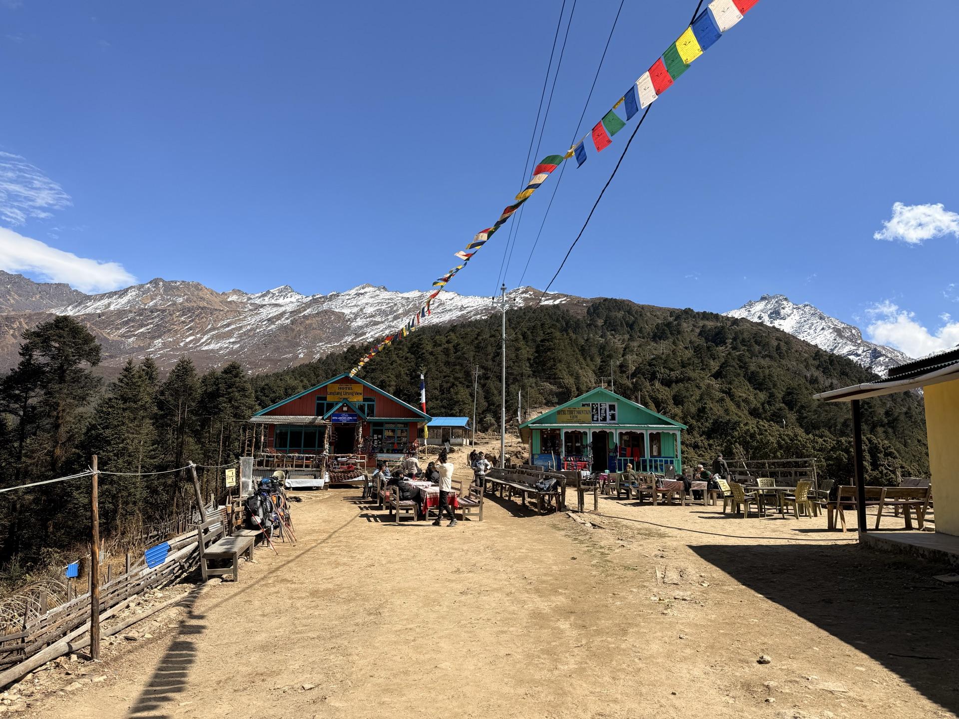 The teahouses of Cholangpati under a long string of prayer flags